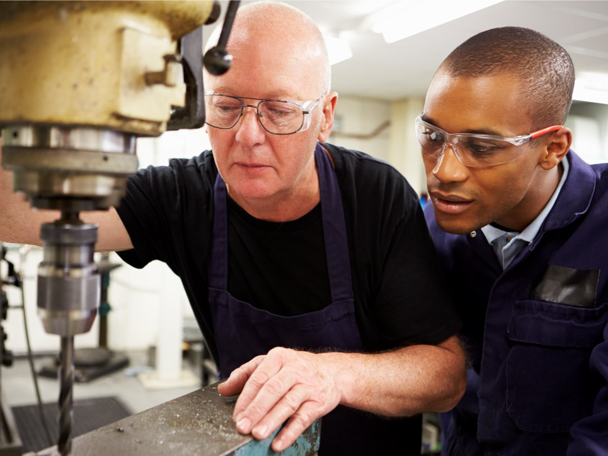 two men looking at a machine