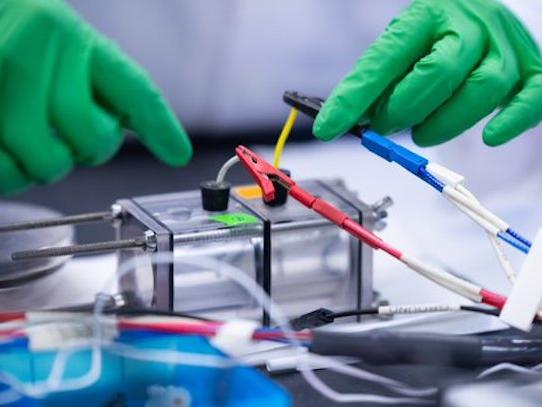 researcher connects a sea water electrolyzer to electricity