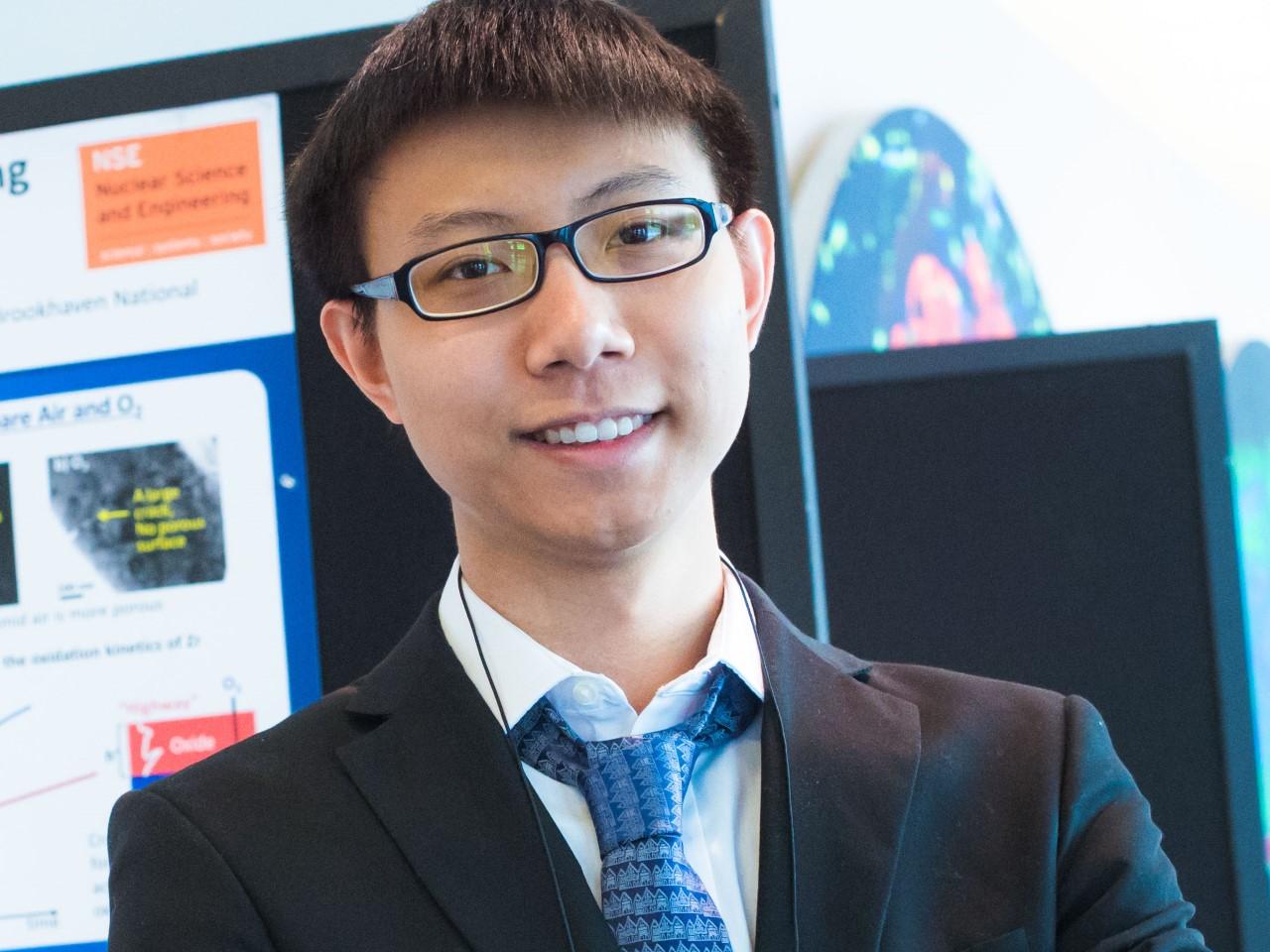 professor in suit and tie smiling and posing