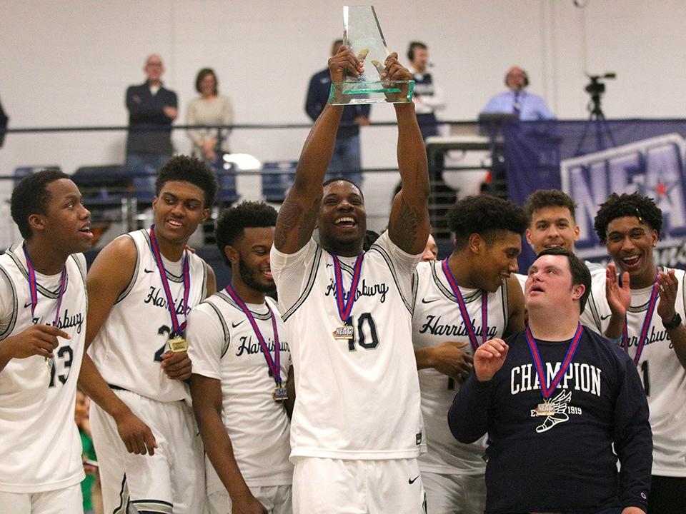 basketball players holding trophy