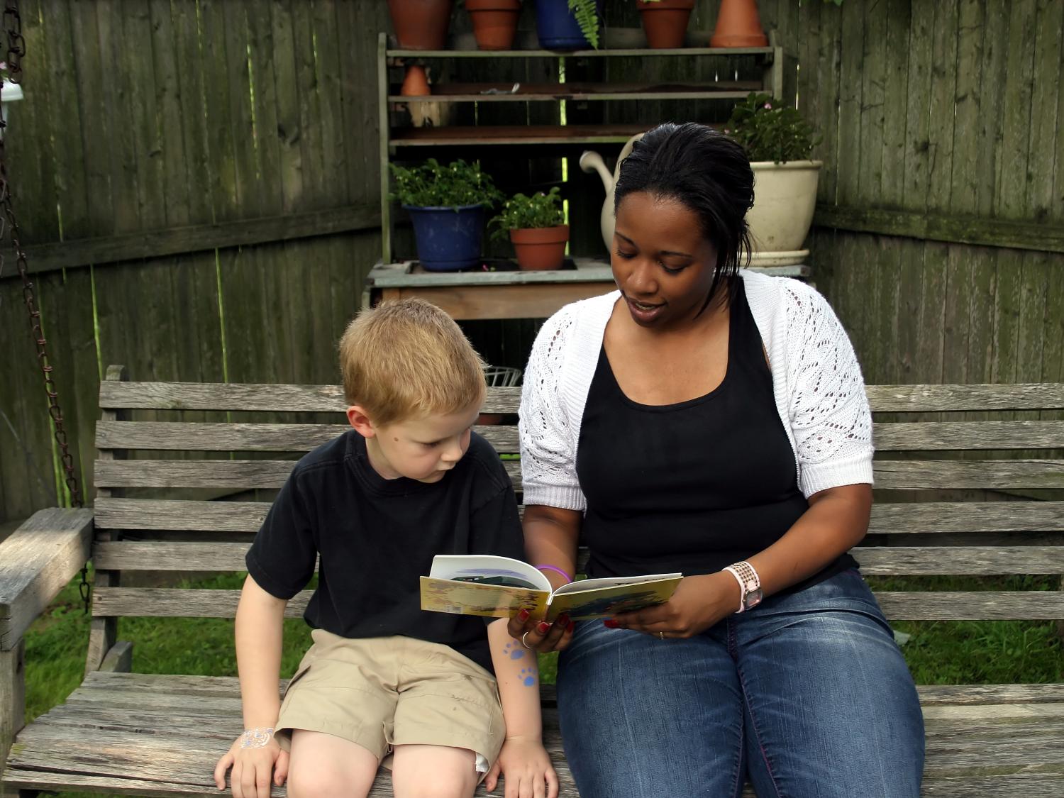 woman reading to boy