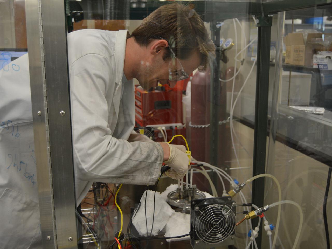 researcher at electrochemical cell