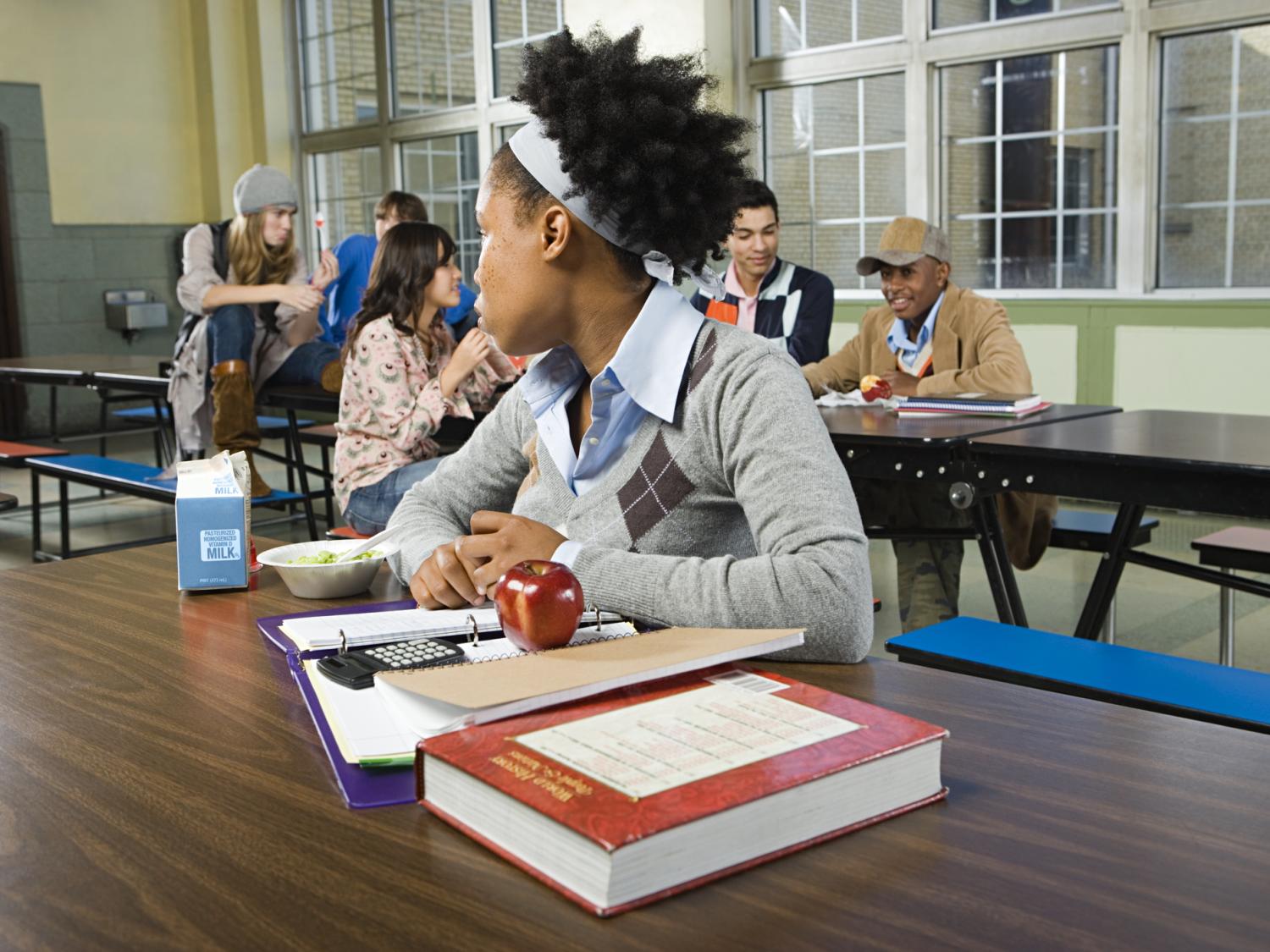 girl alone at lunch table