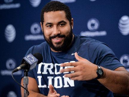 Penn State football All-American guard John Urschel gestures while speaking at a press conference