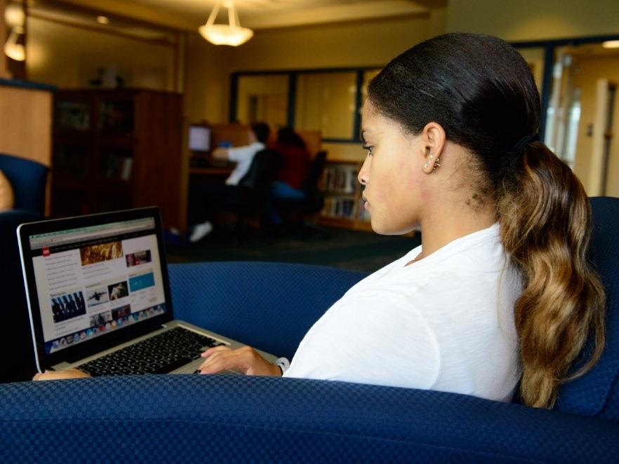 woman at laptop in library