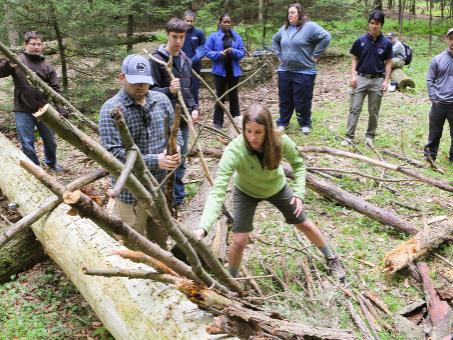 Emergency medicine residents and medical students work in the woods.