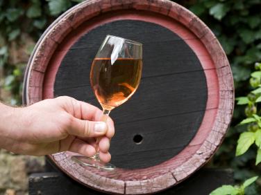 wine cask, hand with wine in glass