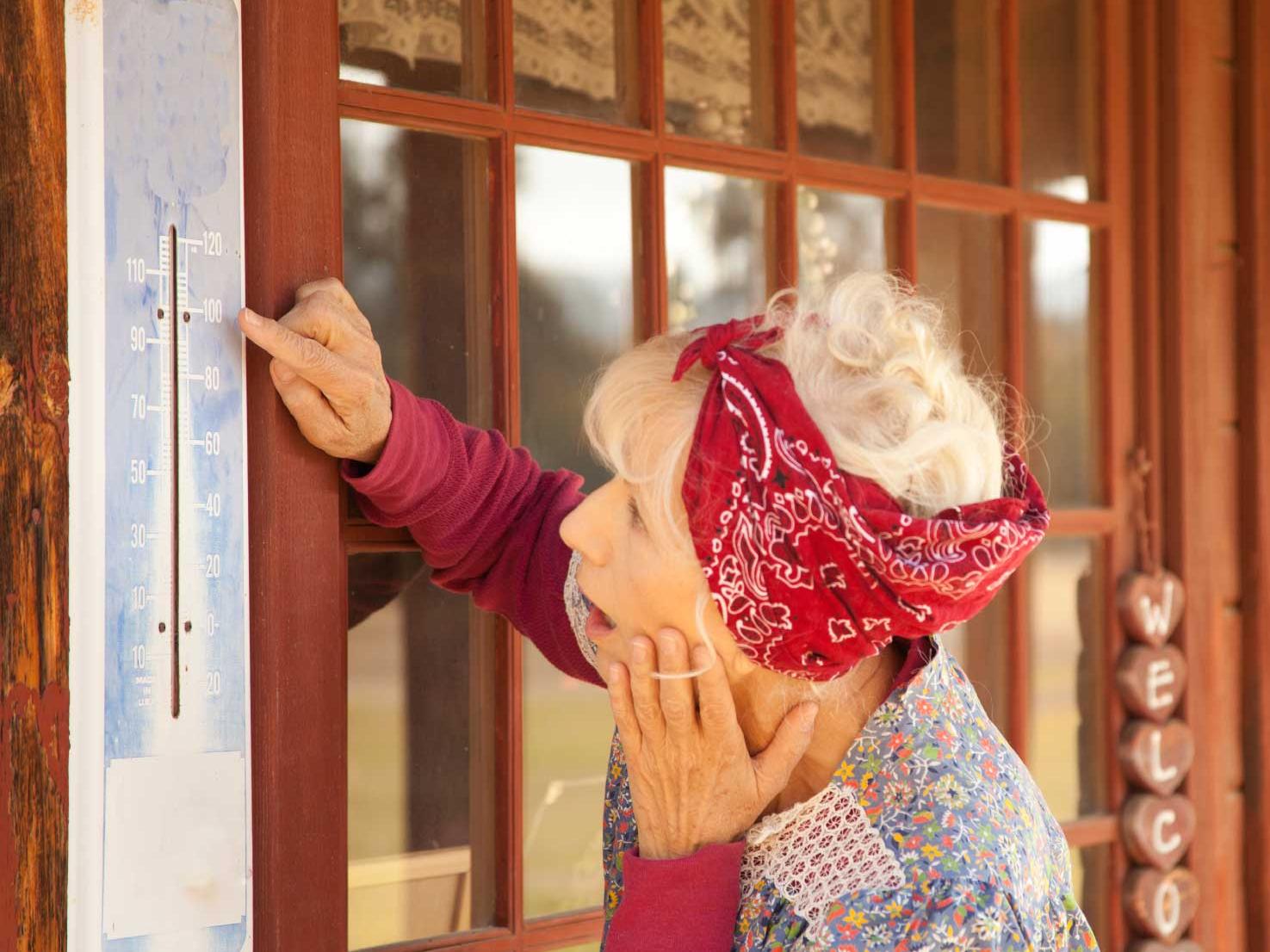 woman with thermometer on hot day