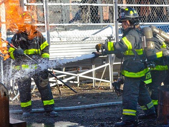 Three women put out fire in barrel using firehose