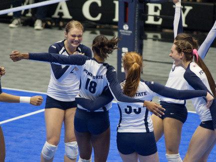 Penn State women's volleyball team members celebrate a point during a 2012 match