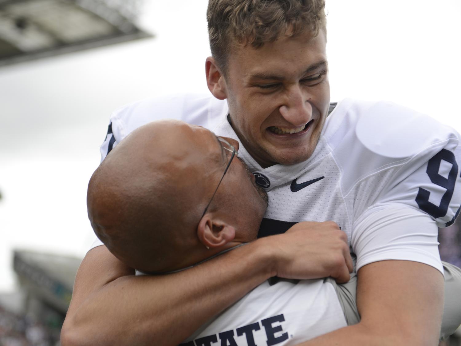 Coach James Franklin and kicker Sam Ficken celebrate Ficken's game-winning field goal.