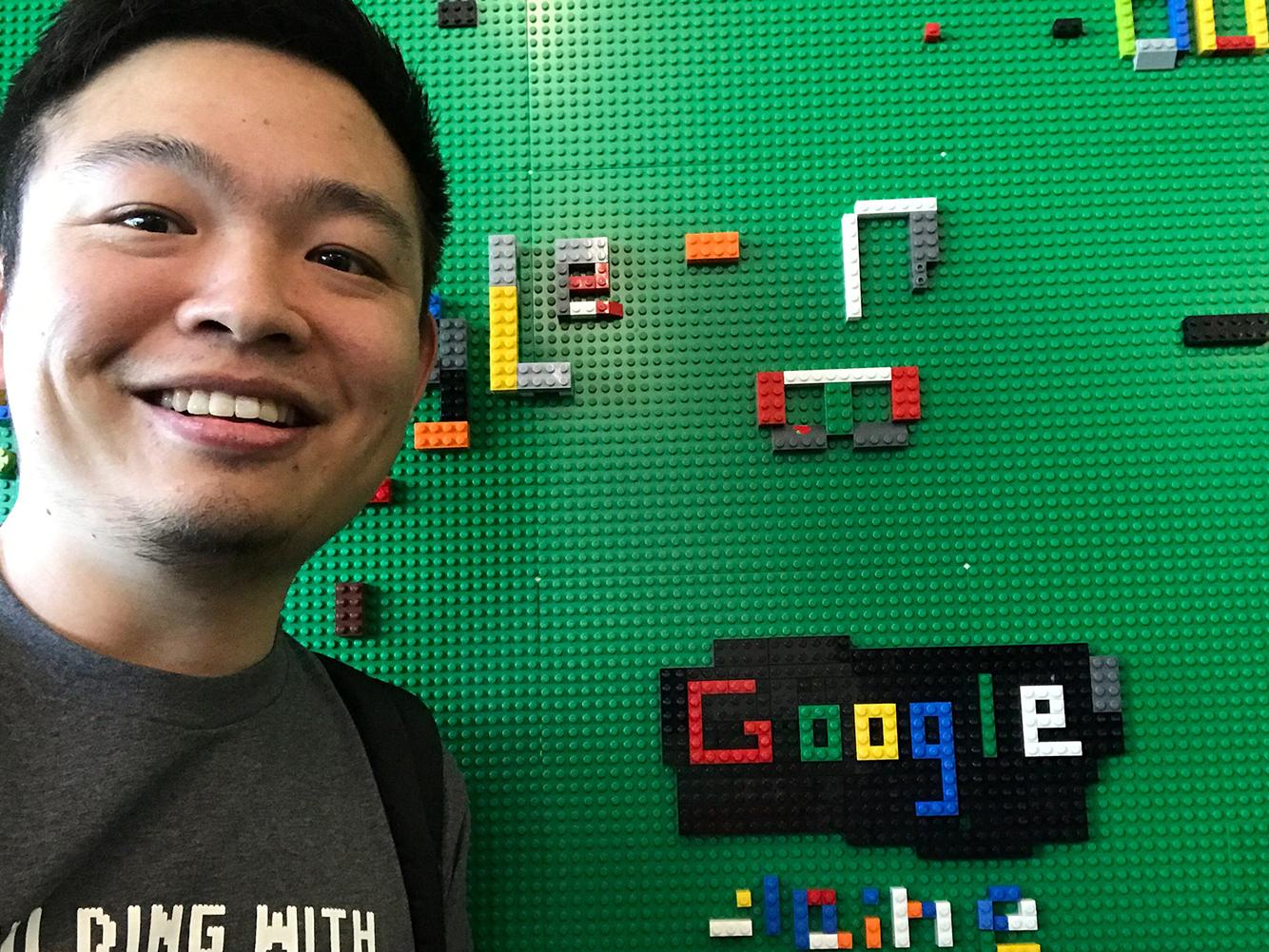 student Xi Liu next to Lego display