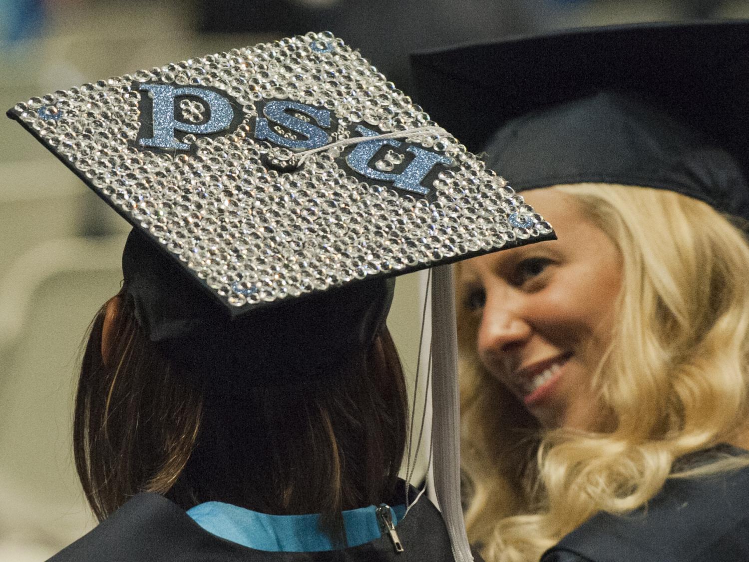 students share a laugh prior to Penn State commencement ceremony