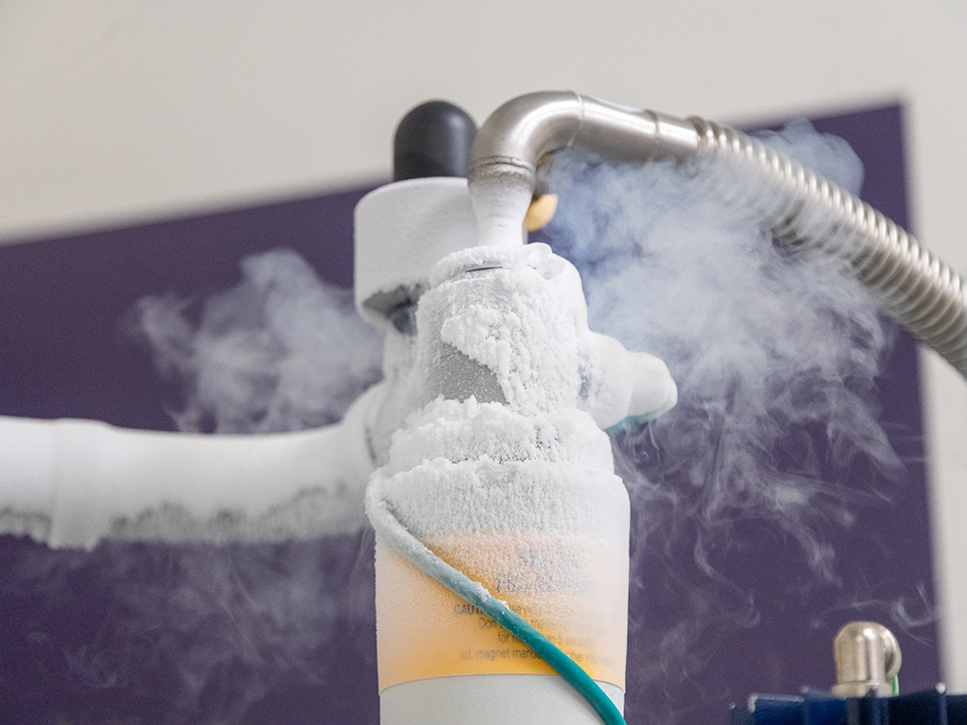 Frost buildup caused by liquid helium's extremely low temperature.