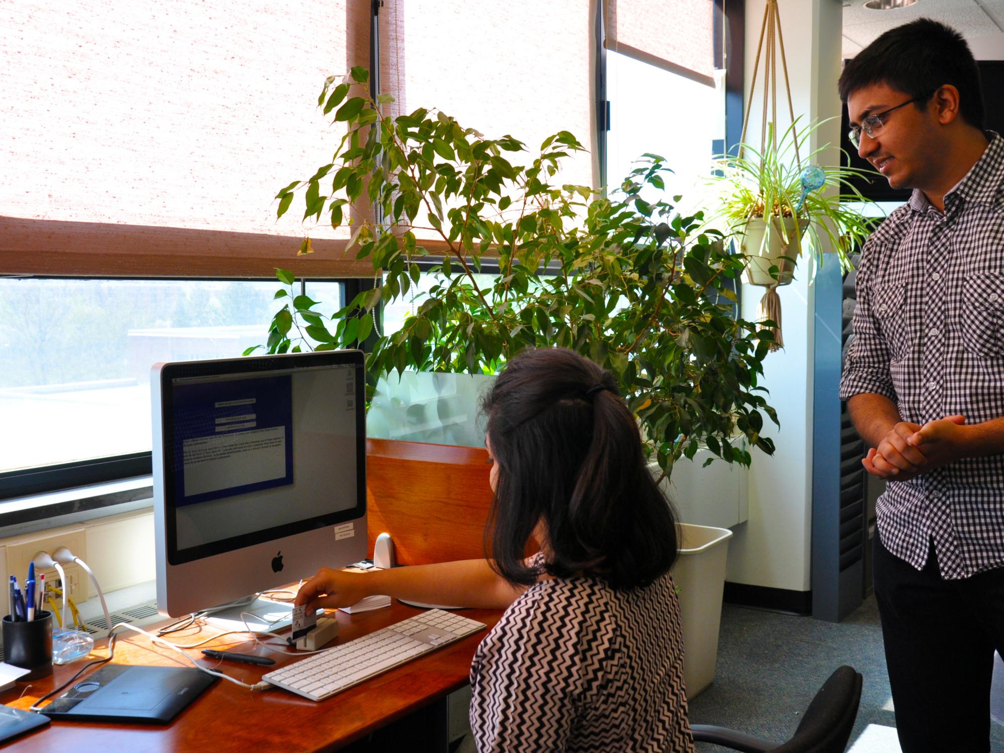 Karan Kalaria helps a student with a technology issue at the IT Service Desk.