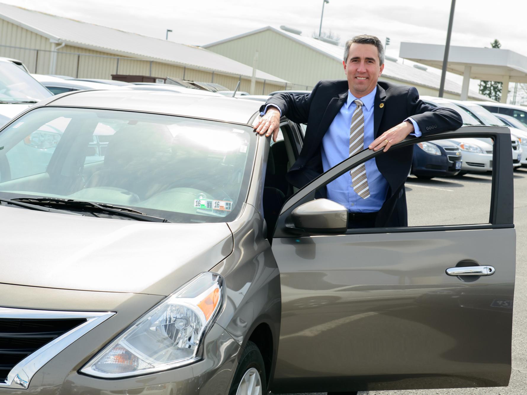 Man standing next to car