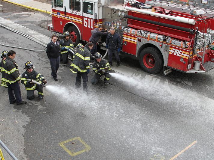 MBA students learn how to wield a fire hose. 