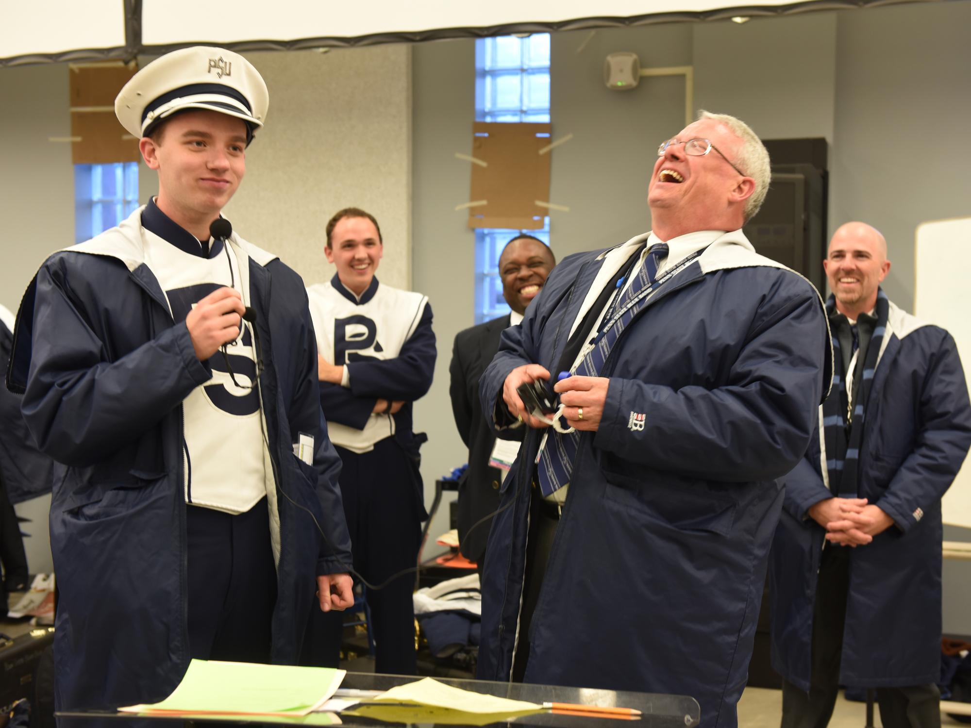 The Blue Band director laughs as the band president announces one final tribute from the band.