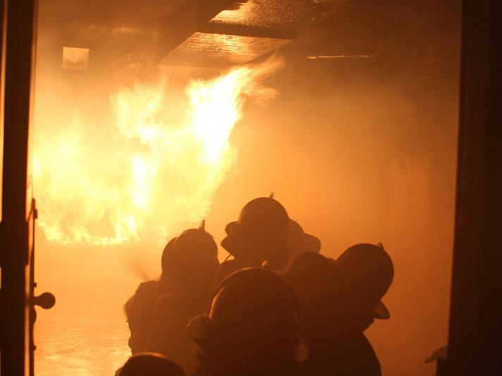 MBA students use the hose to put out a small fire.