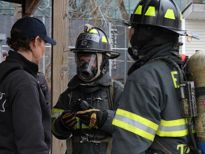 MBA students receive last minute instructions from a firefighter before entering a simulation.
