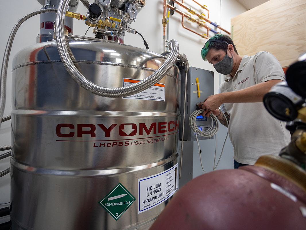​A Cryomech technician works on the Chemistry Building's helium recovery system installation.