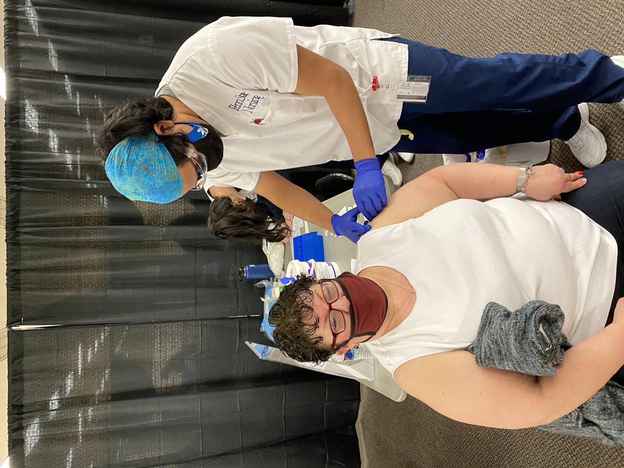 Sophomore Nursing student Josh Phillips administers a vaccine to Pam Howarth (shared with permission).