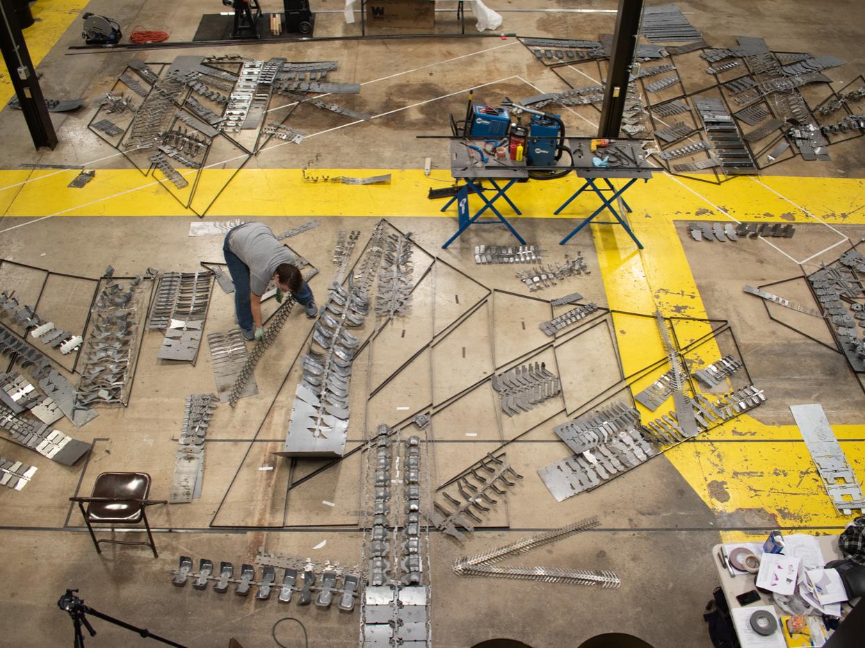 The walls of the chapel are laid out on the floor of the Laundry Building prior to being affixed to the framework.