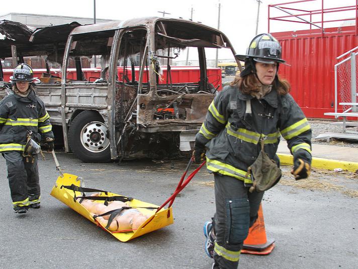 MBA students simulate approaching the scene of a bus attack. 