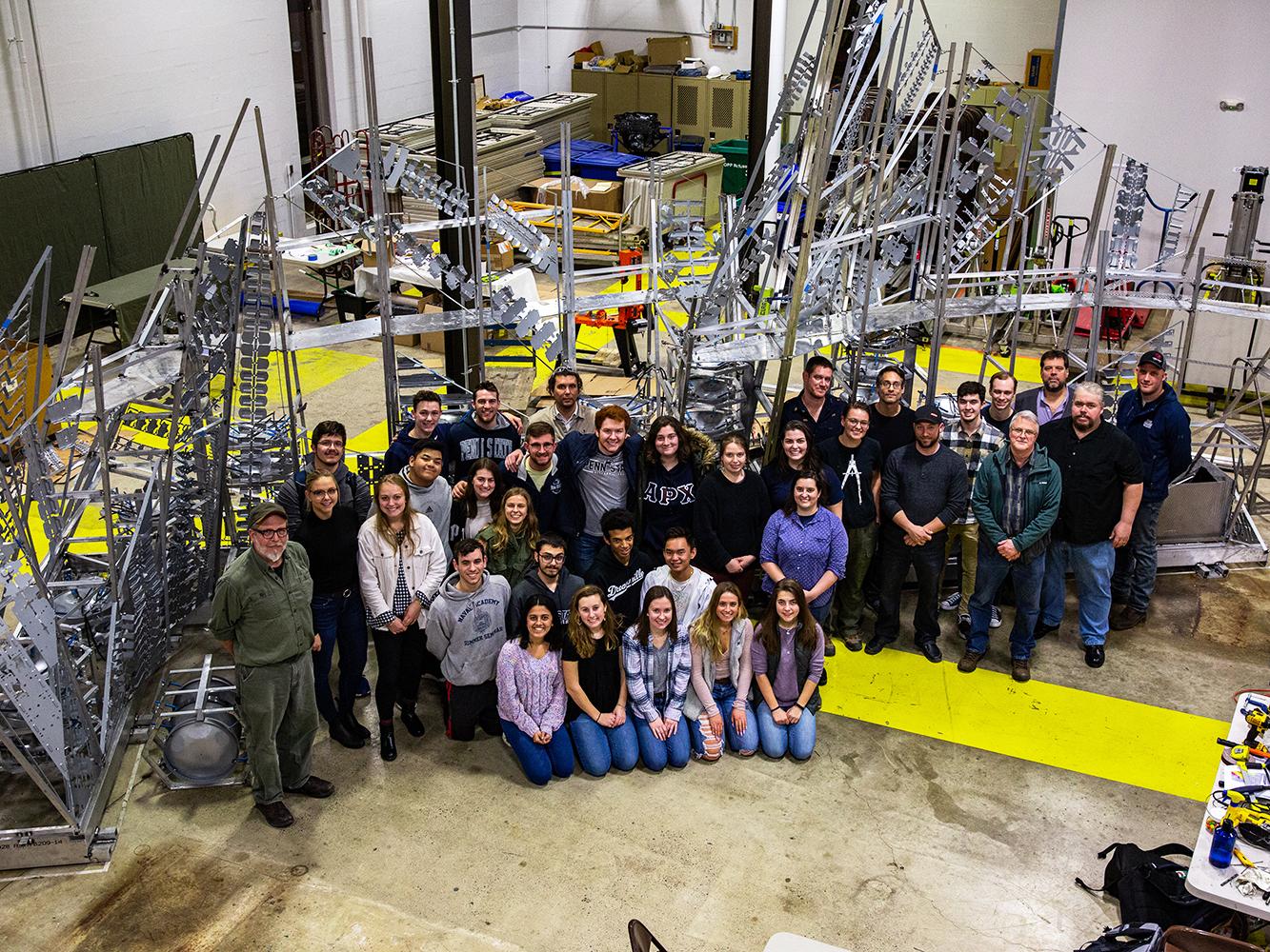 Members of the Penn State team and the Penn College team pose with the completed chapel in the Laundry Building