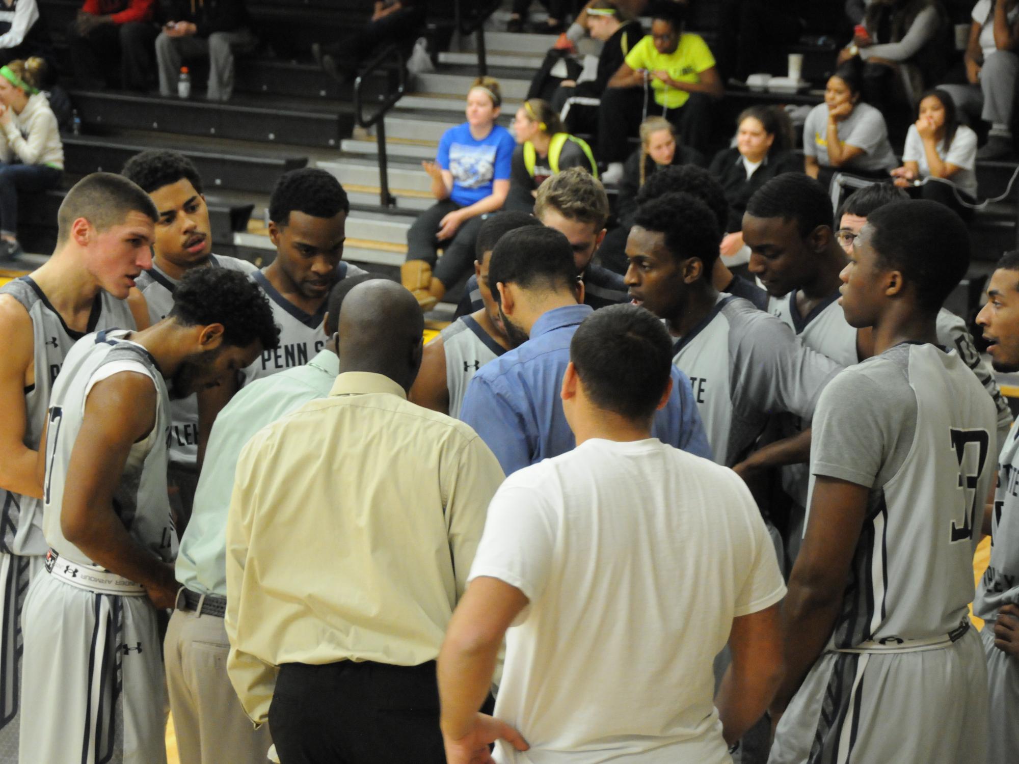 Men's basketball team huddled