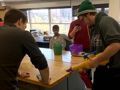 Students demonstrating a vacuum cleaner