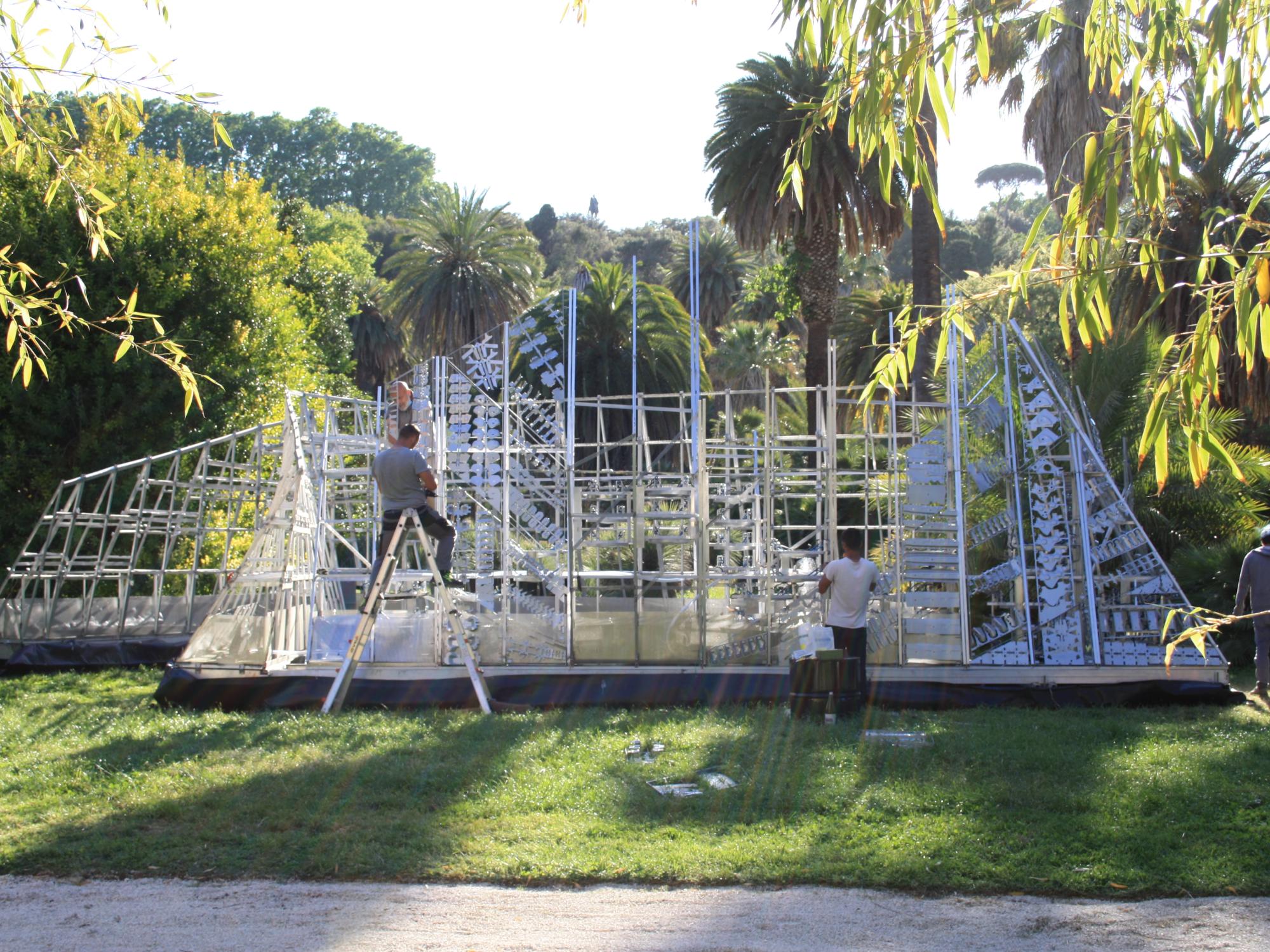 Two workers assembling the chime wall. 