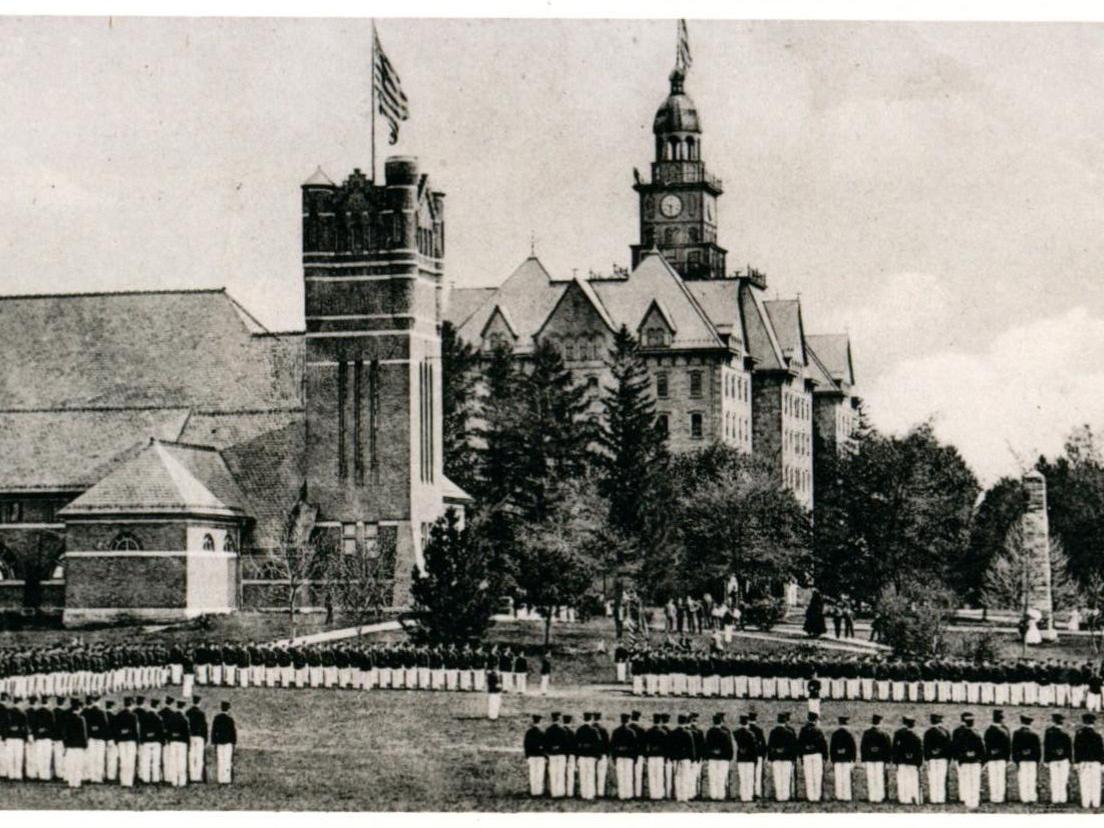 Penn State cadets stand near the Armory and Old Main in 1910