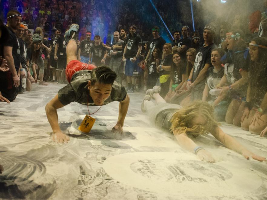 students sliding on a mat