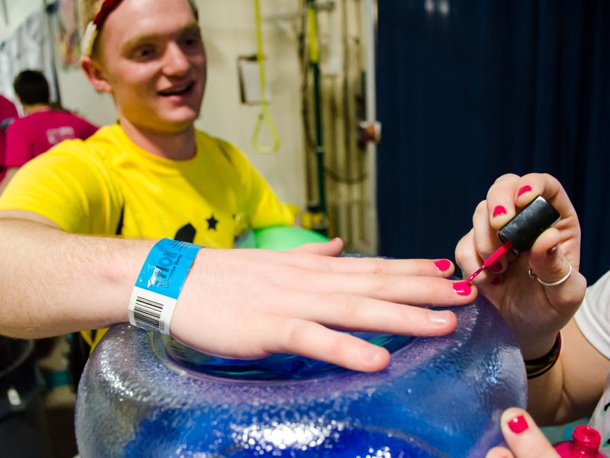 A students gets his fingernails painted 