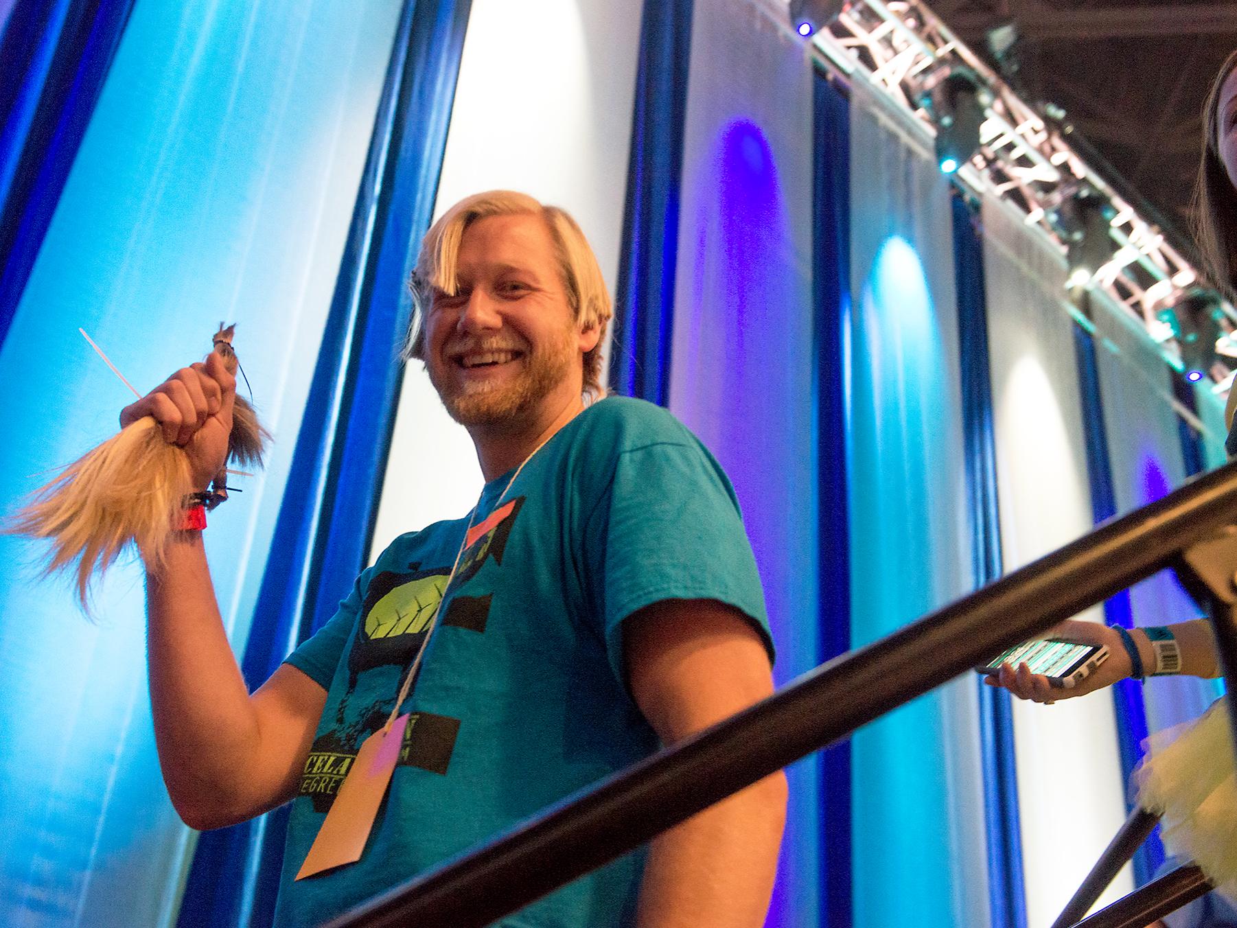 Adam Phoebe holding his cut ponytail at THON 2015