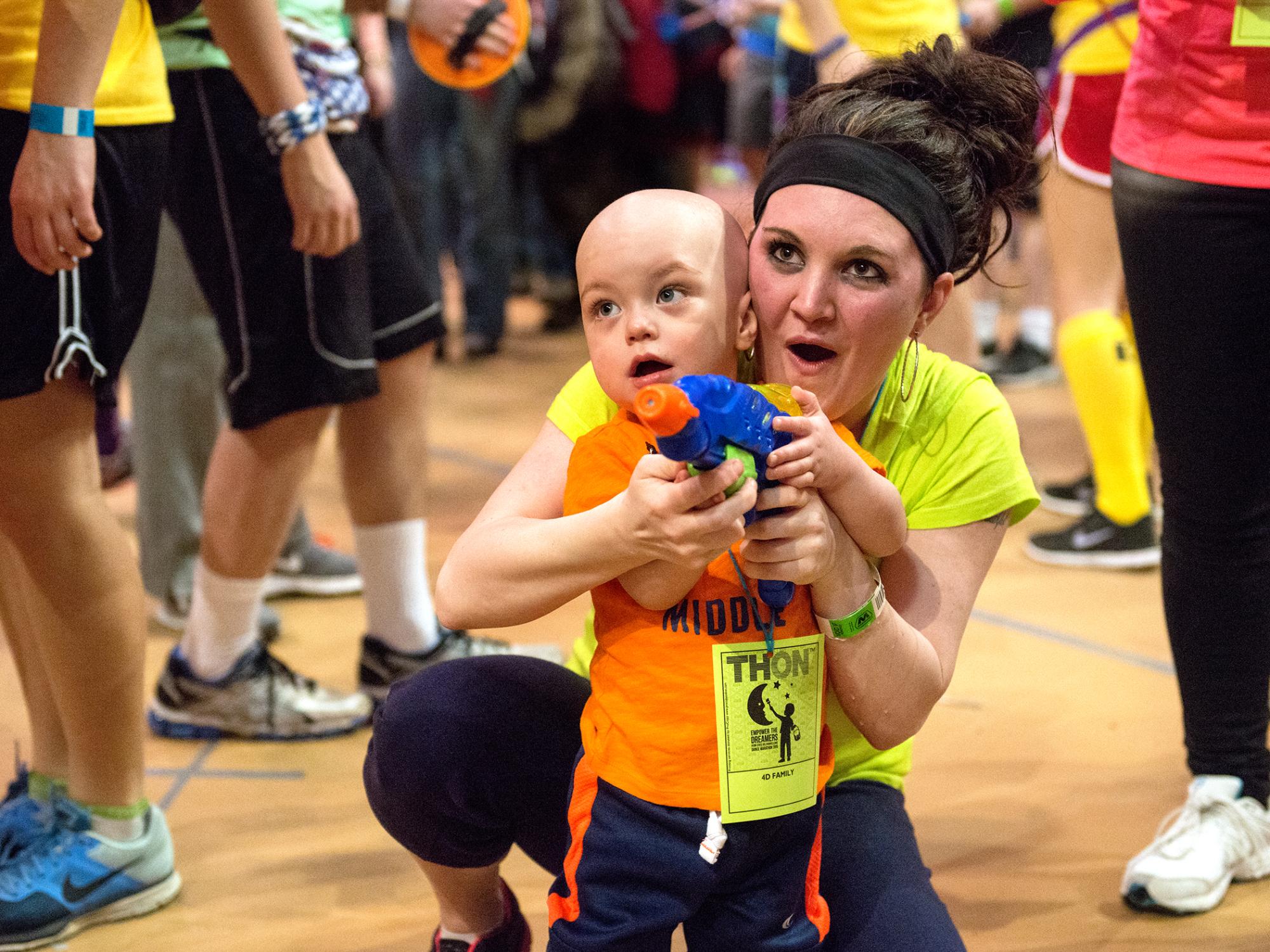 Mom and son playing with a squirtgun at THON 2015