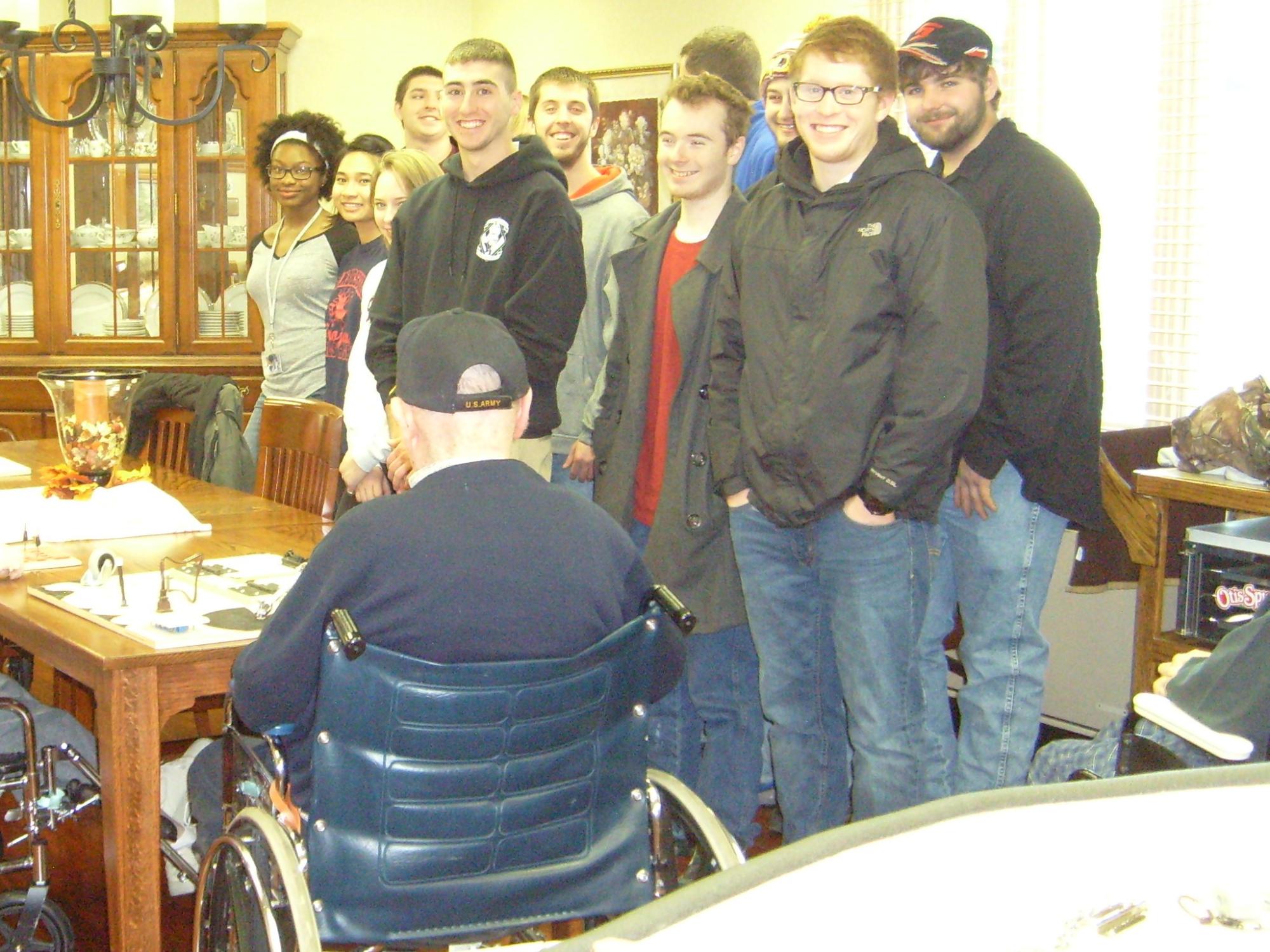 Students in the Introduction to Engineering Design class meet with the residence at Quincy Village to test the prototypes of their projects.