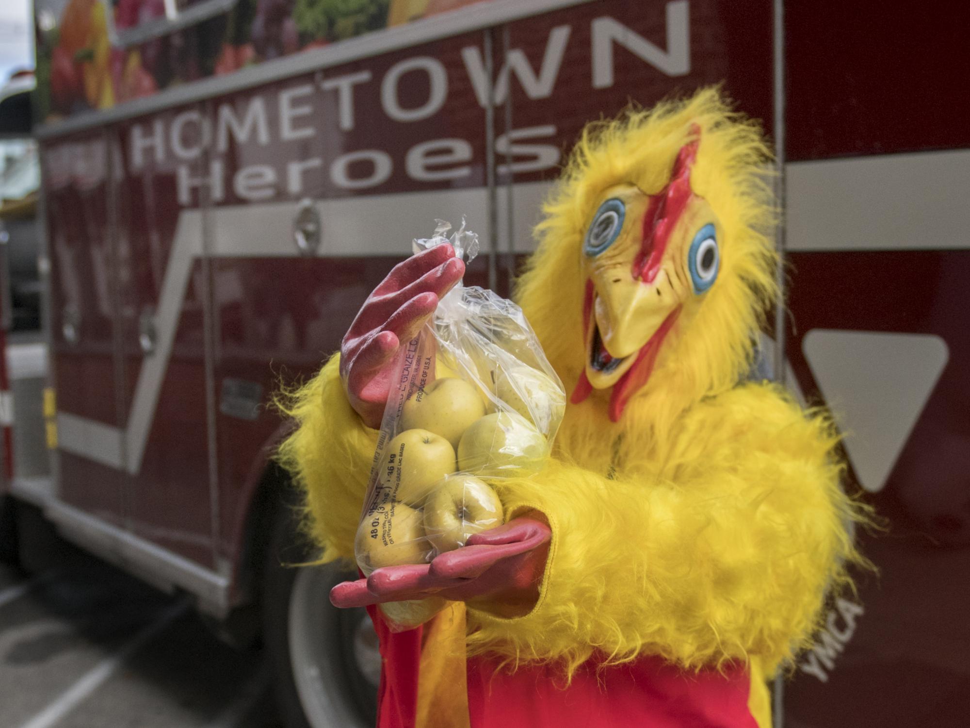 Chicken suit volunteer at YMCA food distribution