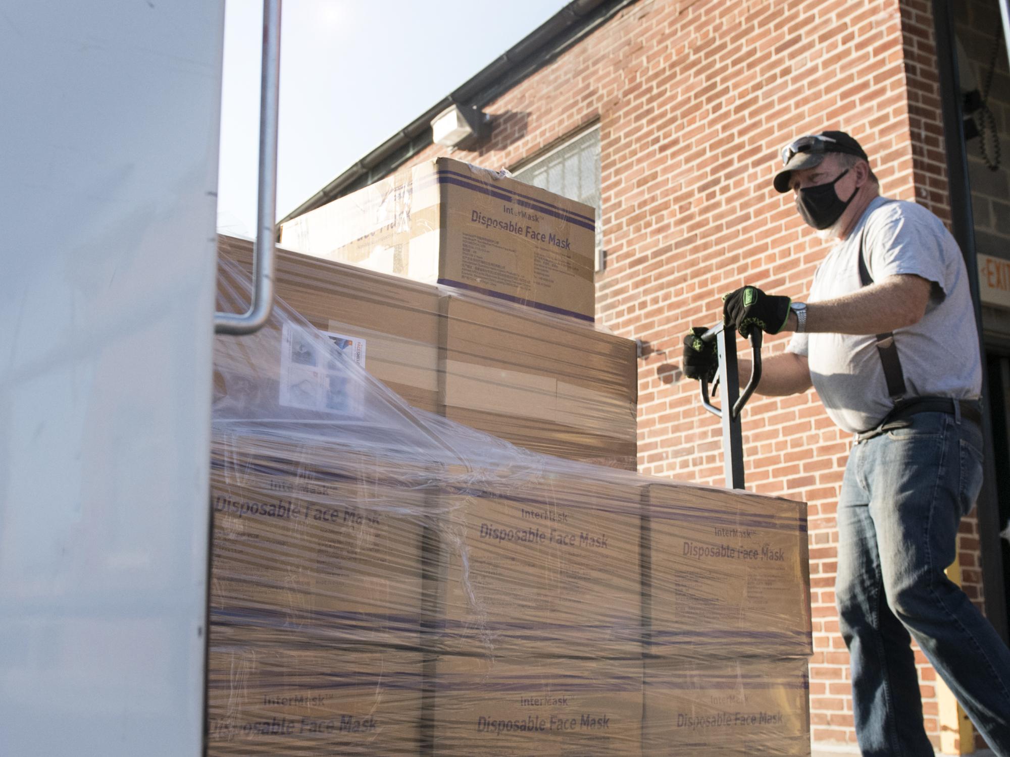 Man loads disposable face masks on truck
