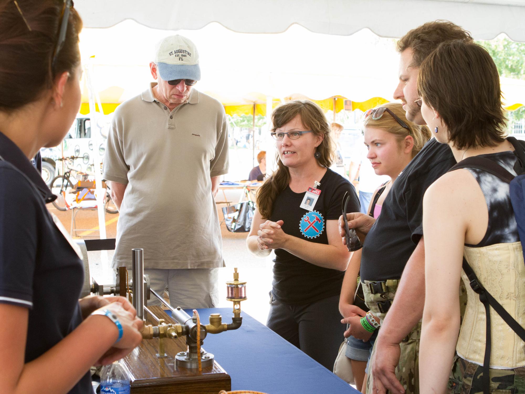 Clara Deck of the Henry Ford Museum talks with Penn State Beaver students about their Henry Ford engine