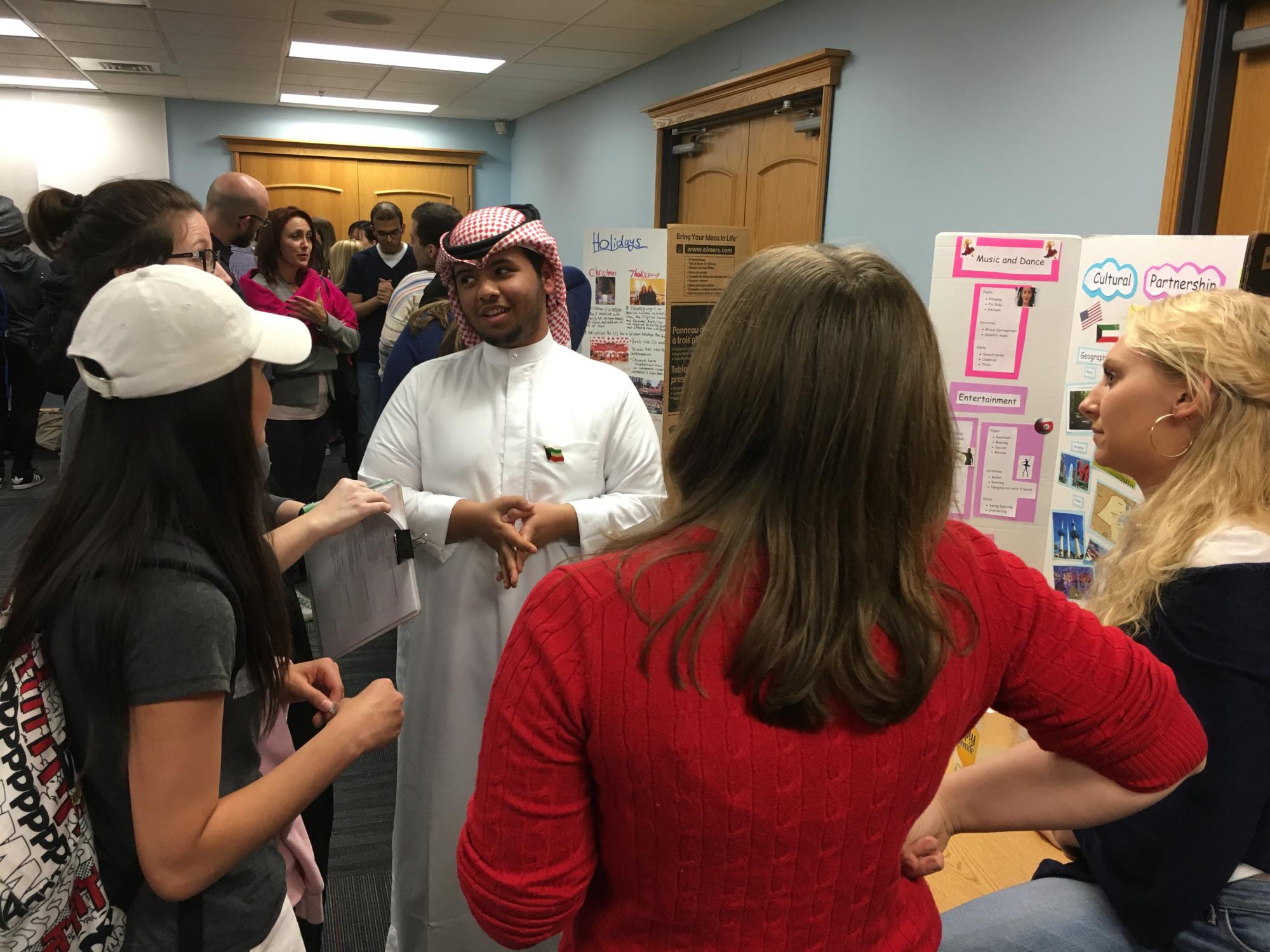 Attendees of the first Many Faces of Intercultural Dialogue talk with poster presenters 