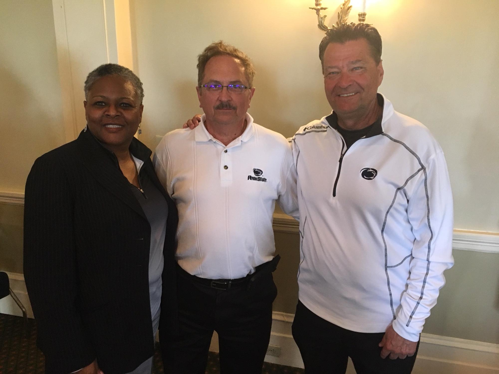 three people smiling at camera