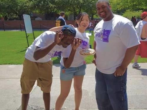 Three friends pose for the camera during an outside event at Penn State.