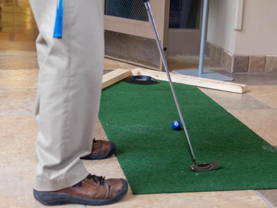 Feet of a person putting on small green. 