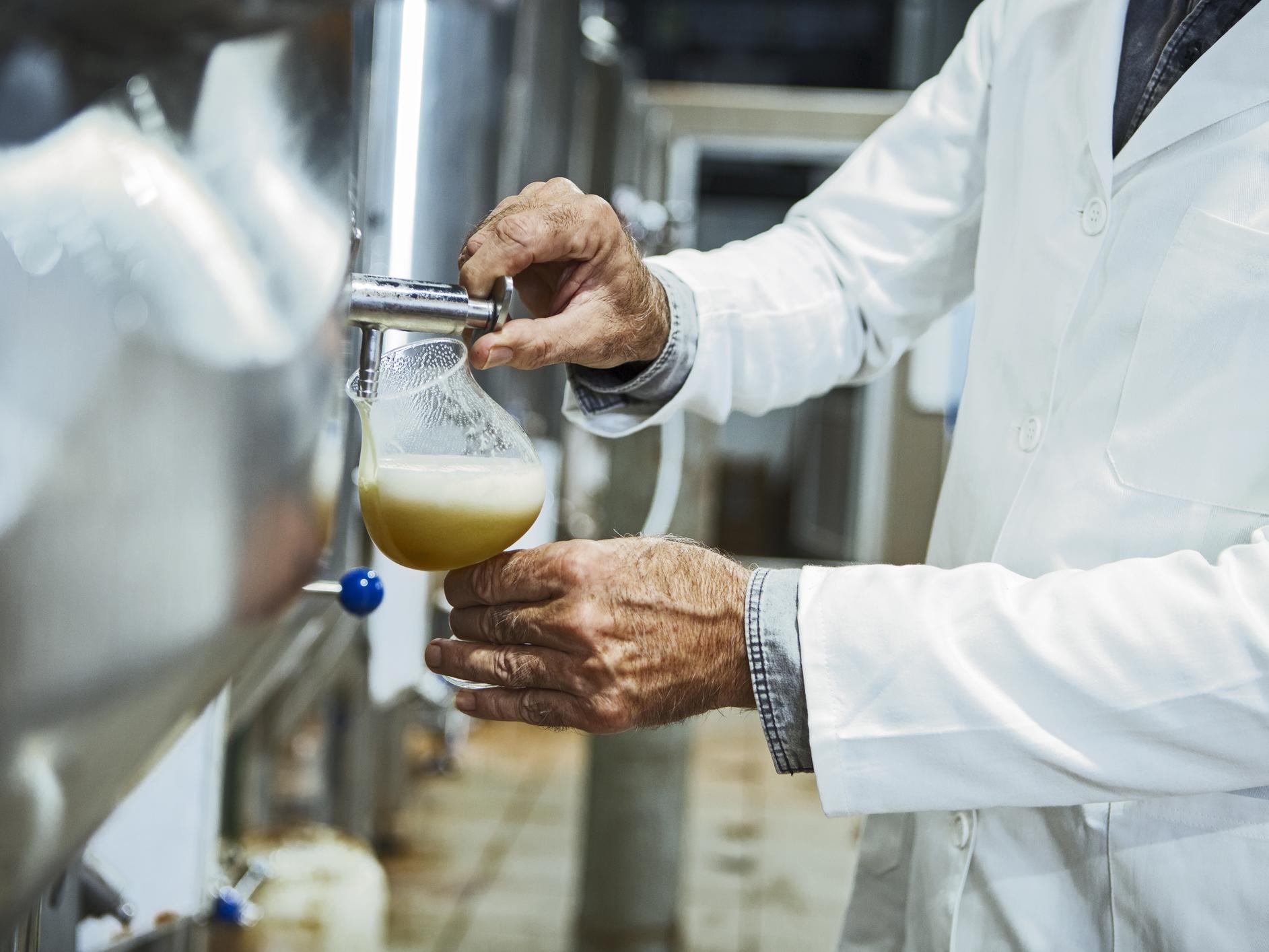 brewer pouring beer