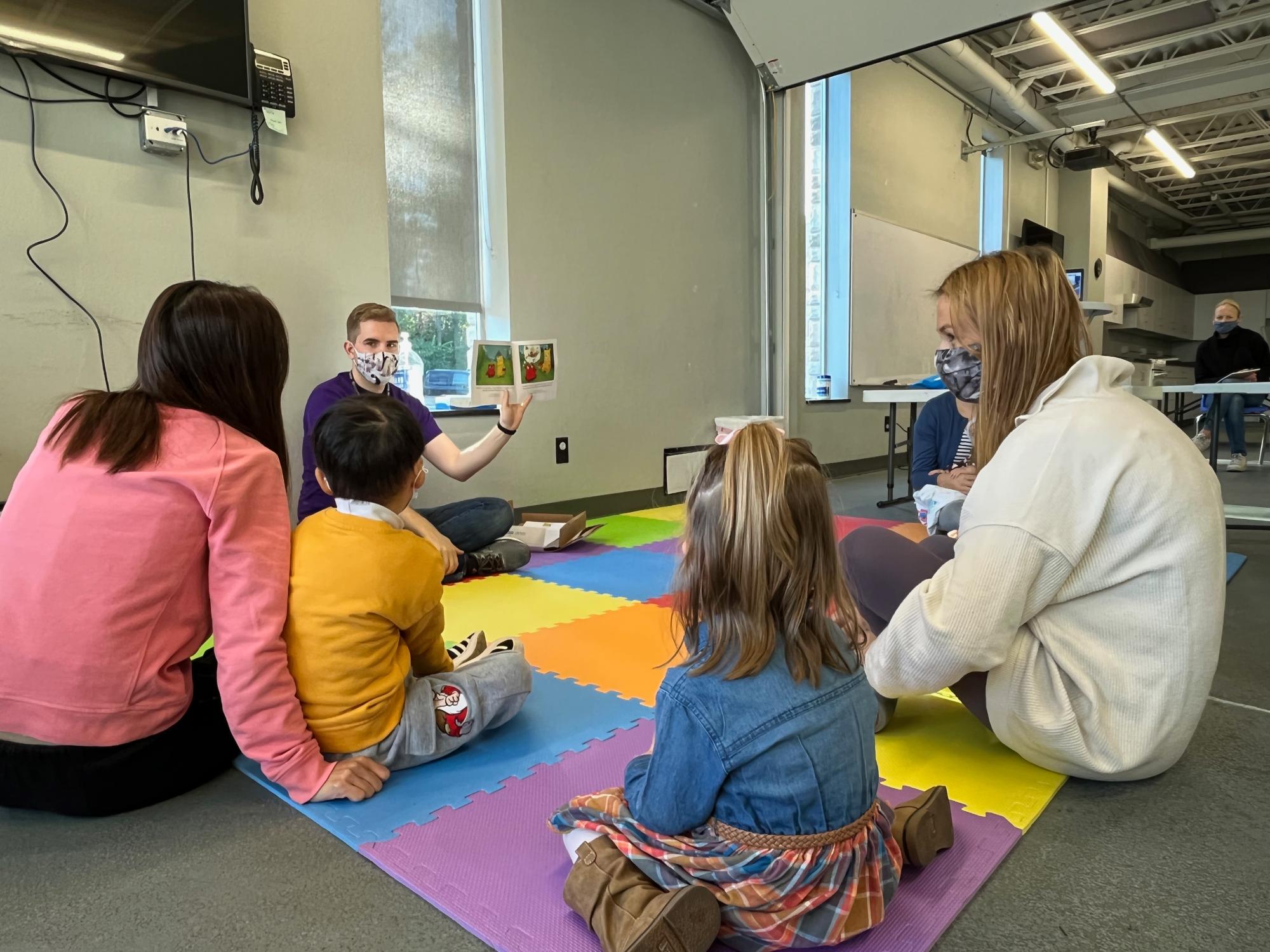 teacher reads a childrens story while the class listens