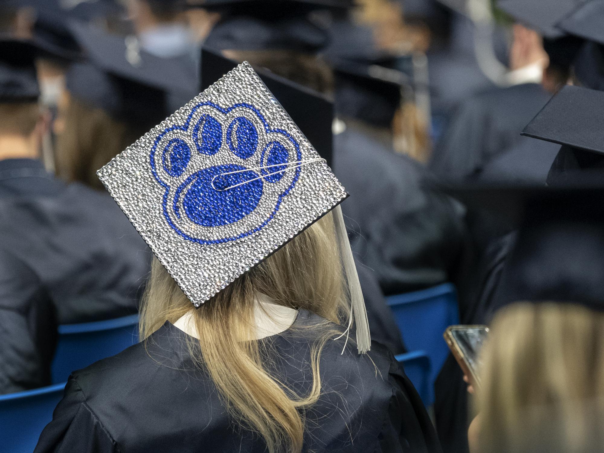 graduate with lion paw mortar board