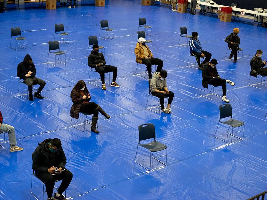 socially distanced students await COVID test results