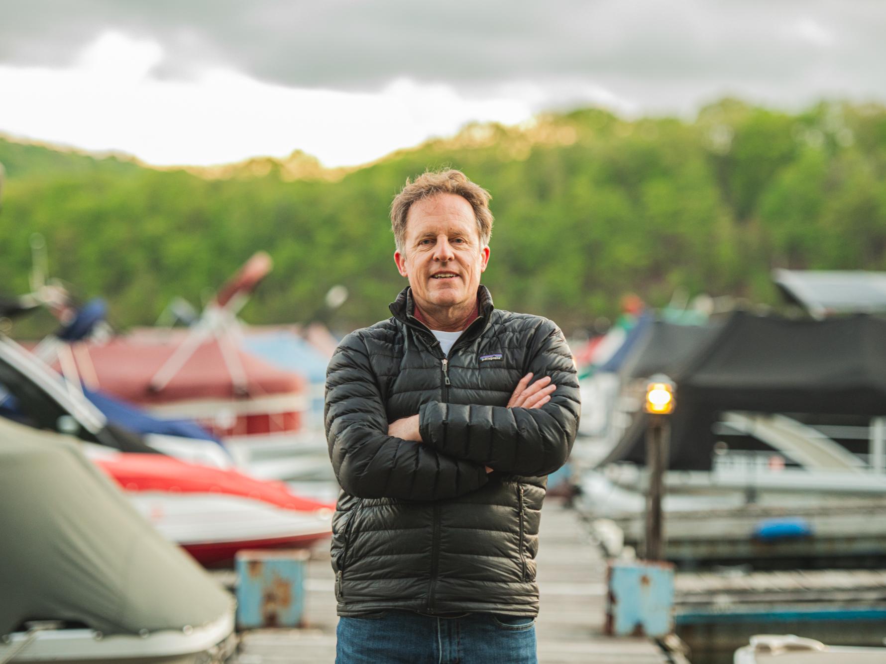 Lee Kump, John Leone Dean in the College of Earth and Mineral Sciences, stands on a dock lined by boats.
